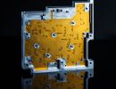 Custom machined product photography on black refelcetive surface.