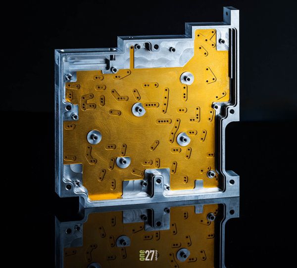 Custom machined product photography on black refelcetive surface.